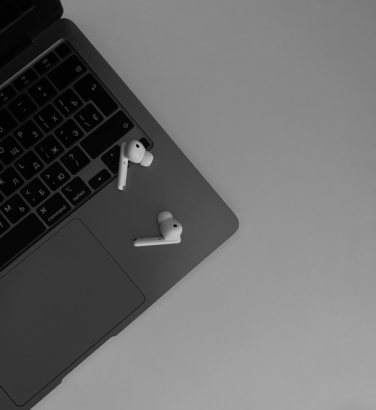Laptop and wireless earbuds — digital services